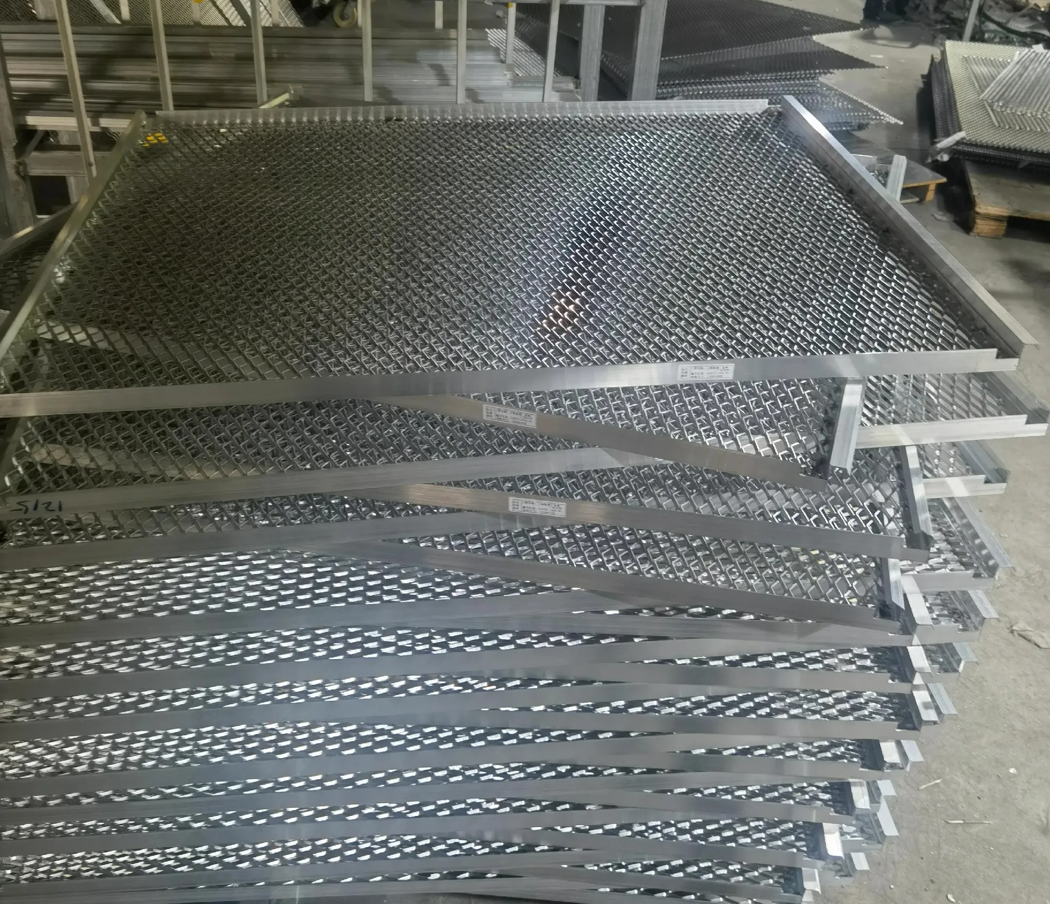 Stacked framed expanded metal panels shown as a visual reference; alloy is not identified