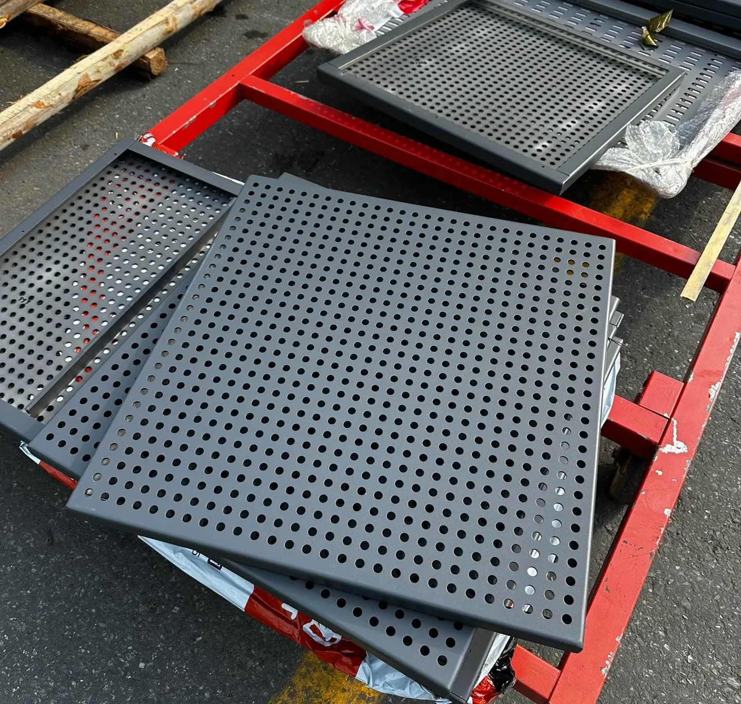 Several framed dark perforated metal panel samples
