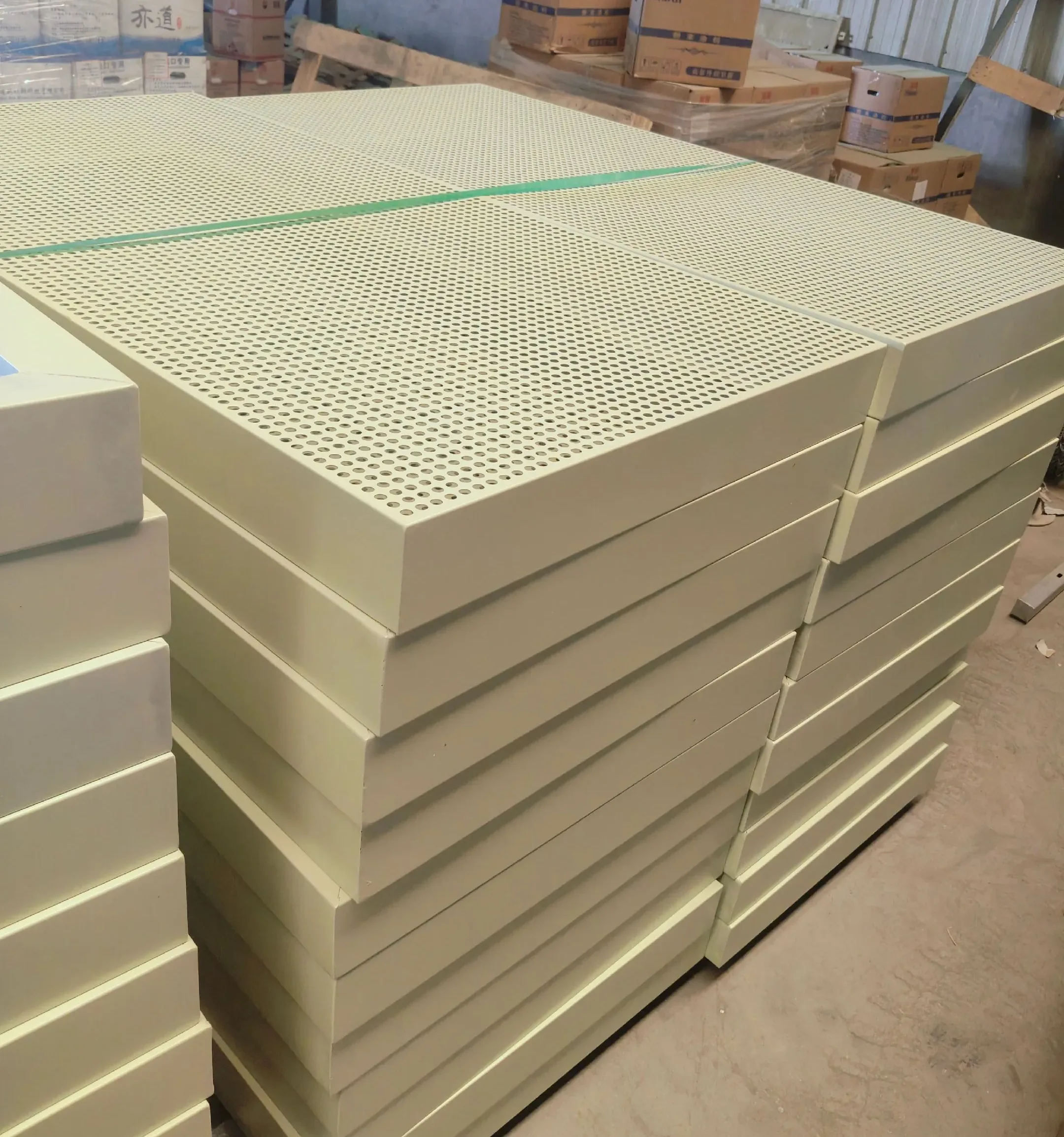 Stack of light-colored perforated metal panel modules